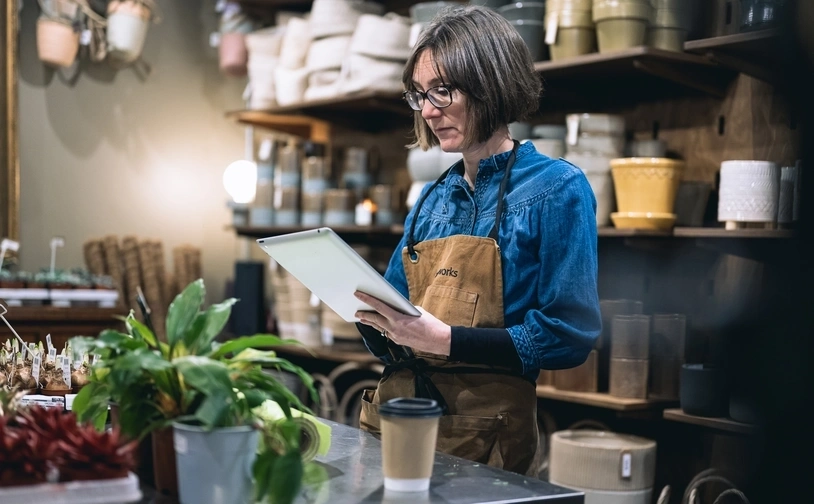 Restaurant staff taking an order using a digital tablet at a professional kitchen pass